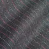 Close-up of dark fabric with wavy red and white stripes, showcasing texture and pattern detail.