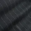 Close-up of grey fabric with subtle diagonal pinstripes creating a textured pattern.