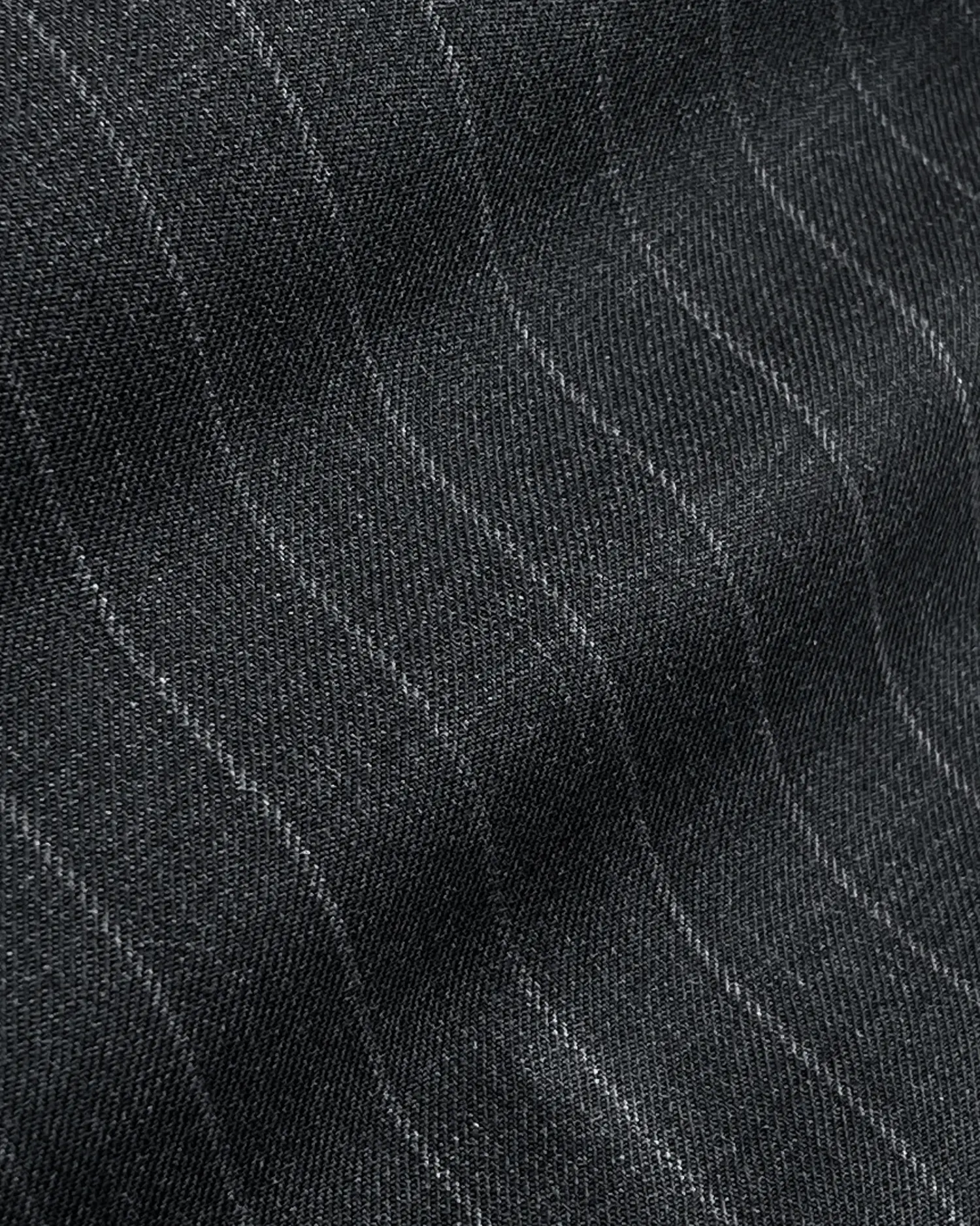 Close-up of grey fabric with subtle diagonal pinstripes creating a textured pattern.