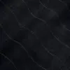 Close-up of black textured fabric with diagonal wave pattern stitches.