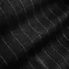Close-up of black denim fabric with subtle striped pattern, showcasing texture and detail.