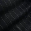 Dark pinstripe fabric texture with subtle wavy lines, ideal for suit or textile design inspiration.