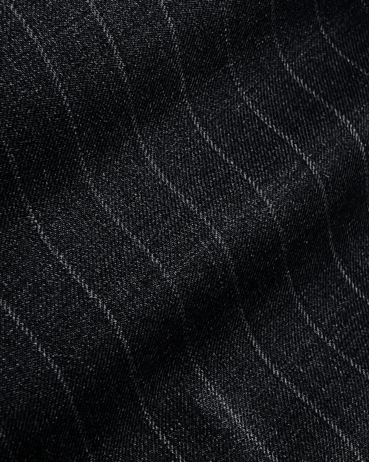 Dark pinstripe fabric texture with subtle wavy lines, ideal for suit or textile design inspiration.
