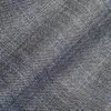 Close-up of blue and gray textured fabric with a subtle plaid pattern.
