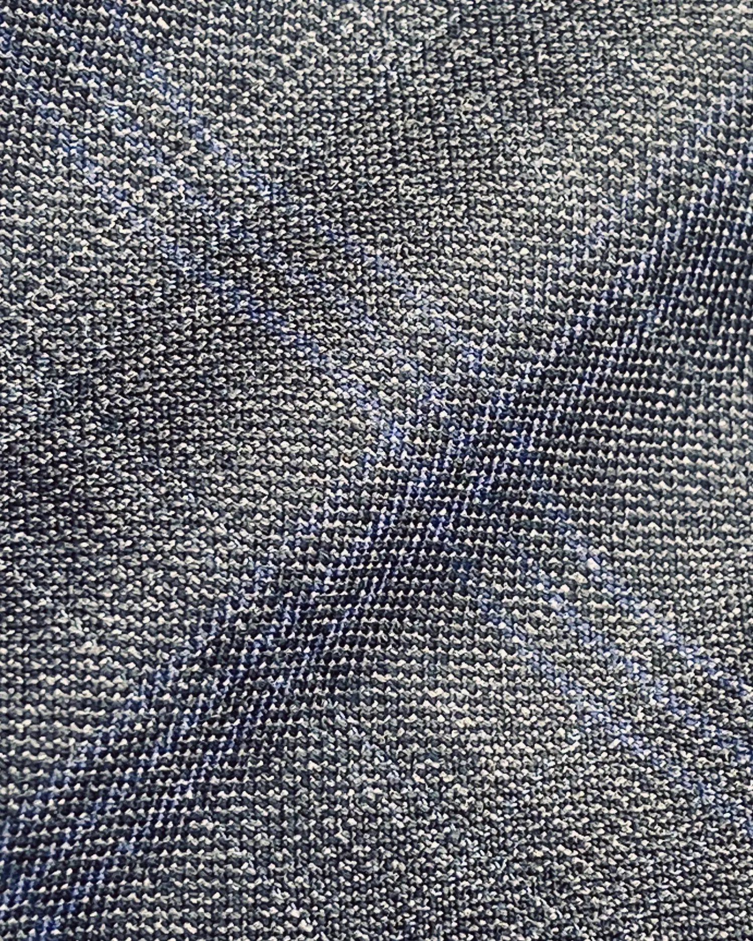 Close-up of blue and gray textured fabric with a subtle plaid pattern.