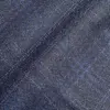 Close-up of textured blue fabric with a subtle checkered pattern, ideal for clothing design and upholstery.