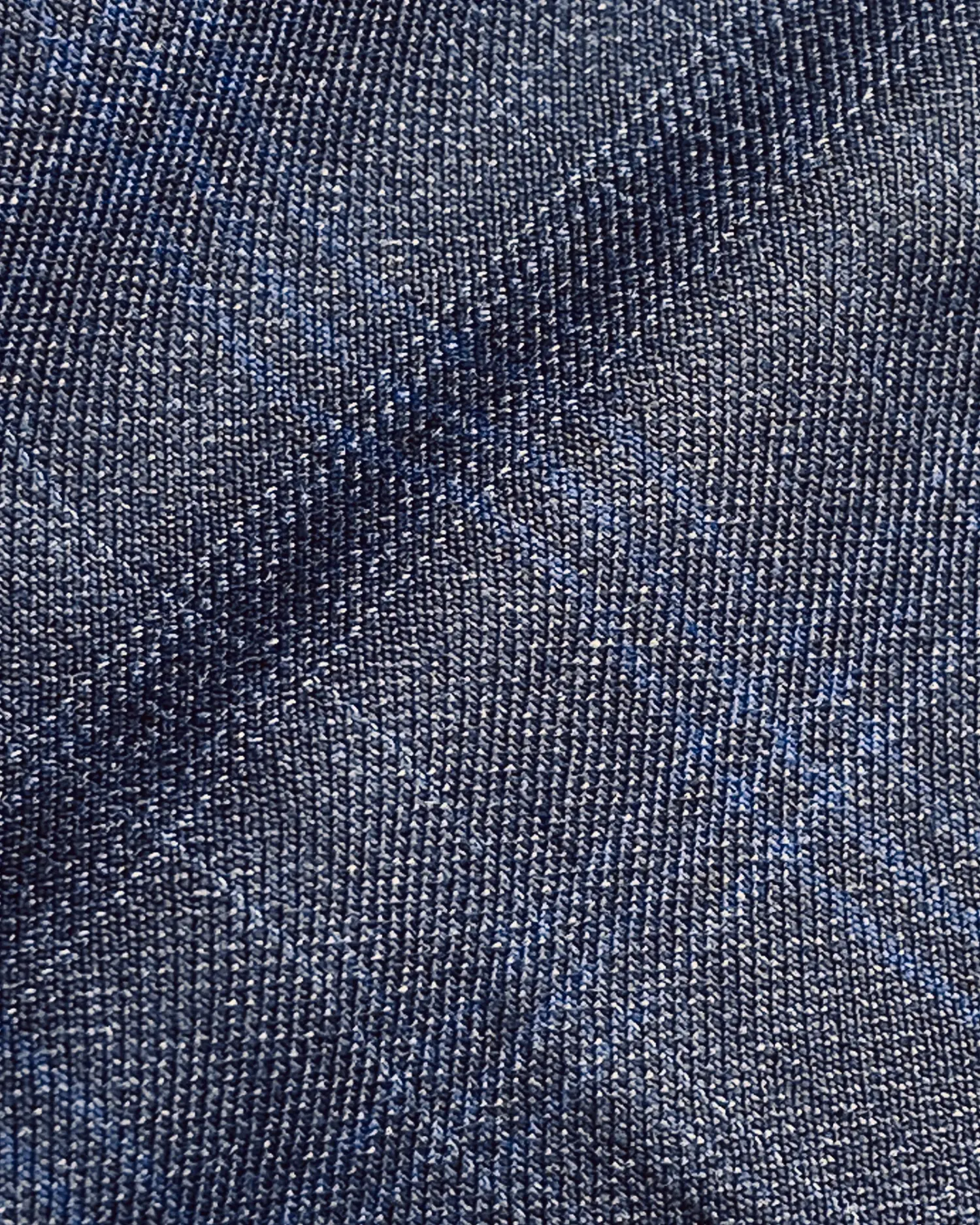 Close-up of textured blue fabric with a subtle checkered pattern, ideal for clothing design and upholstery.