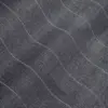 Close-up of gray textured fabric with wavy patterns and fine stitching.