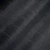 Close-up of dark denim fabric with subtle stitching pattern.