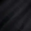 Close-up of black pinstripe fabric with subtle wavy lines, showcasing texture and pattern for clothing design or upholstery.