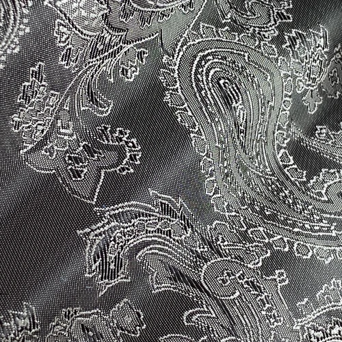 Close-up of intricate paisley pattern on gray fabric showcasing elegant and detailed design elements.
