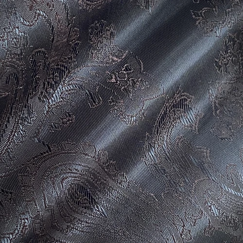 Elegant dark jacquard fabric with intricate floral patterns and a glossy finish, ideal for luxurious textiles.
