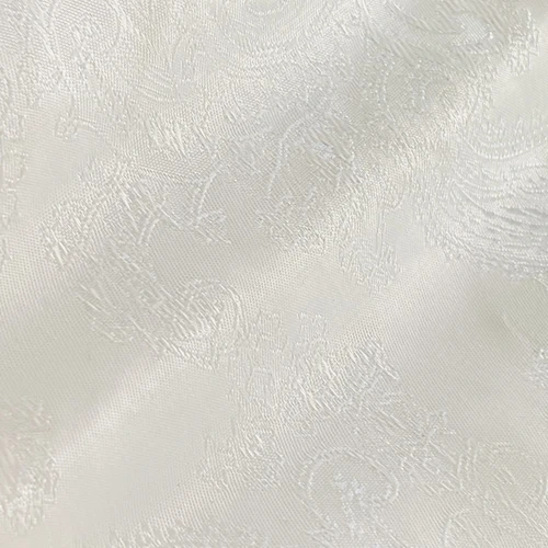 Elegant white jacquard fabric with intricate floral pattern; perfect for clothing, upholstery, or home decor.