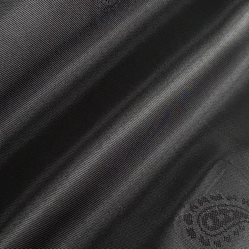 Close-up of black fabric texture with diagonal lines and embossed pattern.