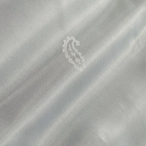 Close-up of a dollar sign pattern on a light gray, textured fabric surface, showcasing detailed embroidery.