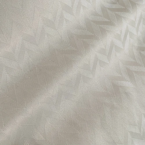 Ivory herringbone pattern fabric with subtle texture and soft sheen, perfect for elegant upholstery or fashion design.