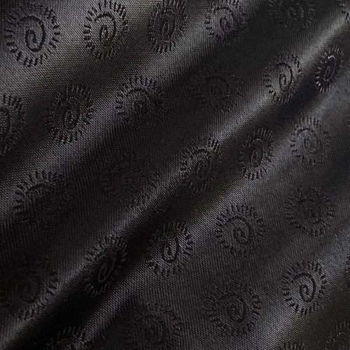 Dark paisley jacquard fabric with intricate spiral patterns, showcasing textured elegance and sophisticated design.