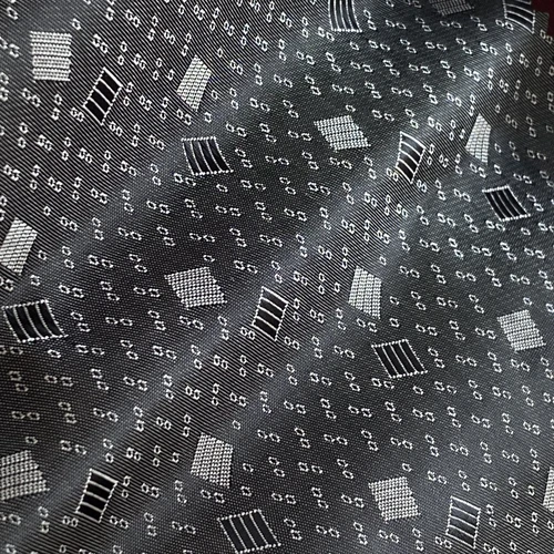 Black and white binary pattern fabric with geometric shapes and numeric code design.