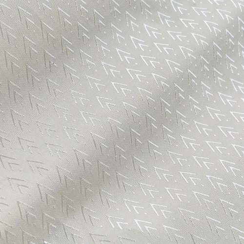 Elegant white fabric with subtle geometric pattern, close-up view, highlighting texture and design.