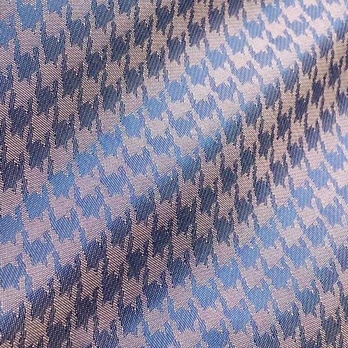 Blue and pink houndstooth fabric pattern, close-up view for fashion design inspiration and textile detail.