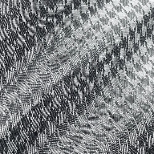 Grey houndstooth fabric texture with a black and white pattern, ideal for fashion or upholstery design concepts.