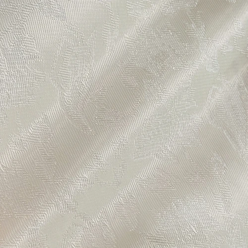 Detailed white floral jacquard fabric texture with intricate patterns on a diagonal fold.