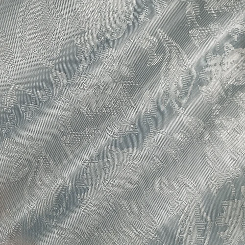Elegant silver fabric with a textured, floral pattern, showcasing intricate design and refined craftsmanship.