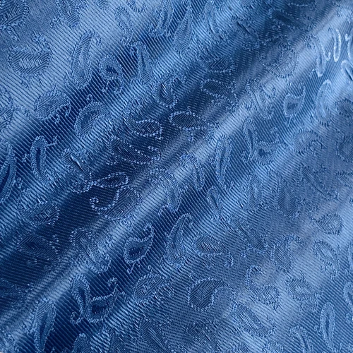 Blue paisley patterned silk fabric with intricate design and glossy texture.