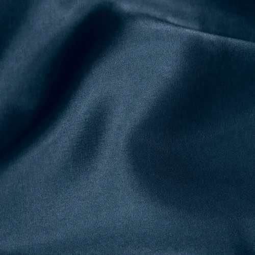 Close-up of smooth, dark blue fabric with gentle folds, showcasing its texture and quality.
