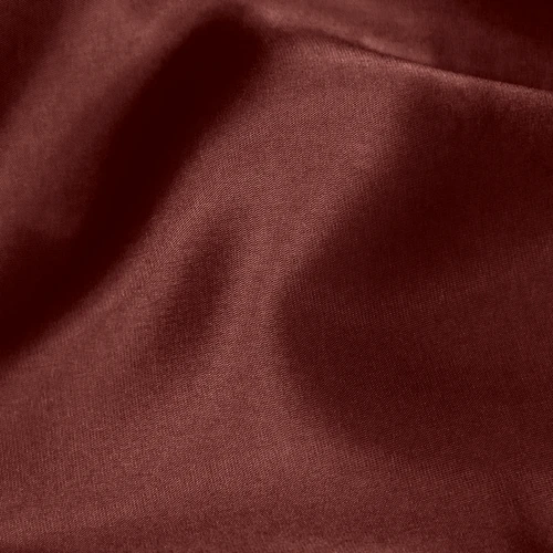 Rich burgundy silk fabric with smooth texture and gentle folds, ideal for luxury fashion or home decor.
