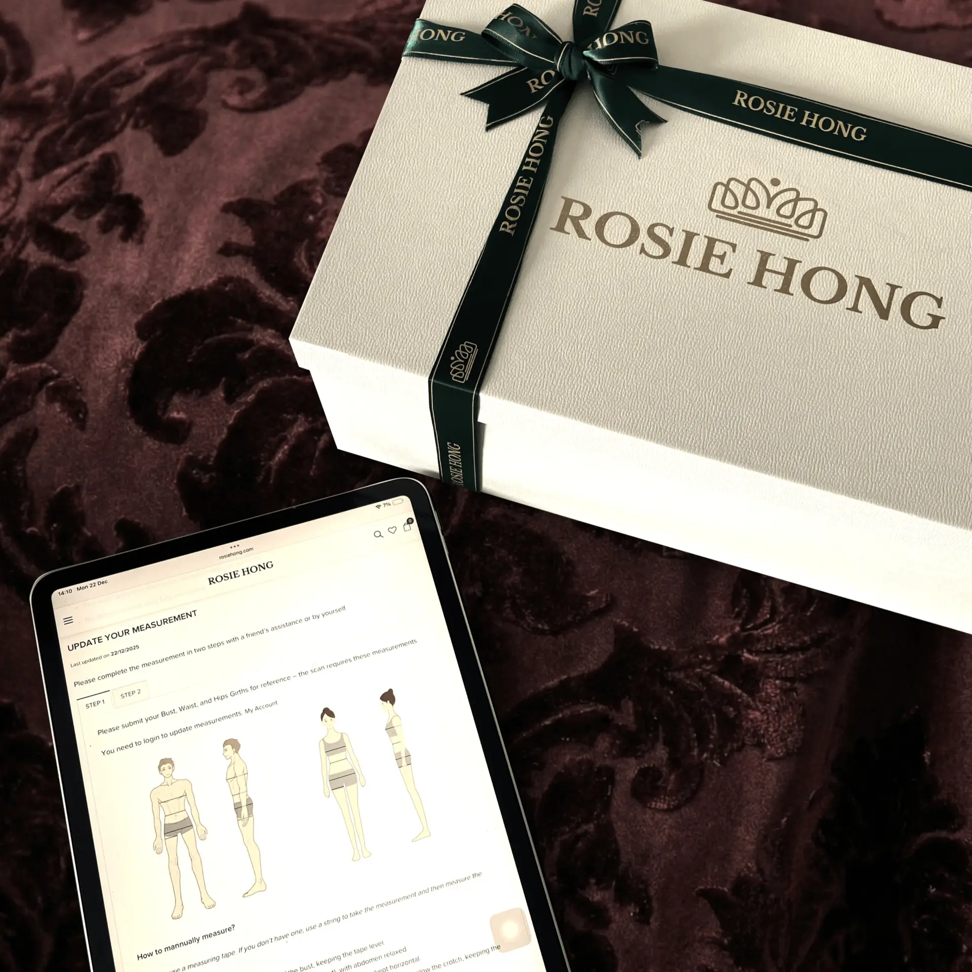 Luxury gift box with Rosie Hong branding and a tablet displaying measurement instructions on a velvet background.
