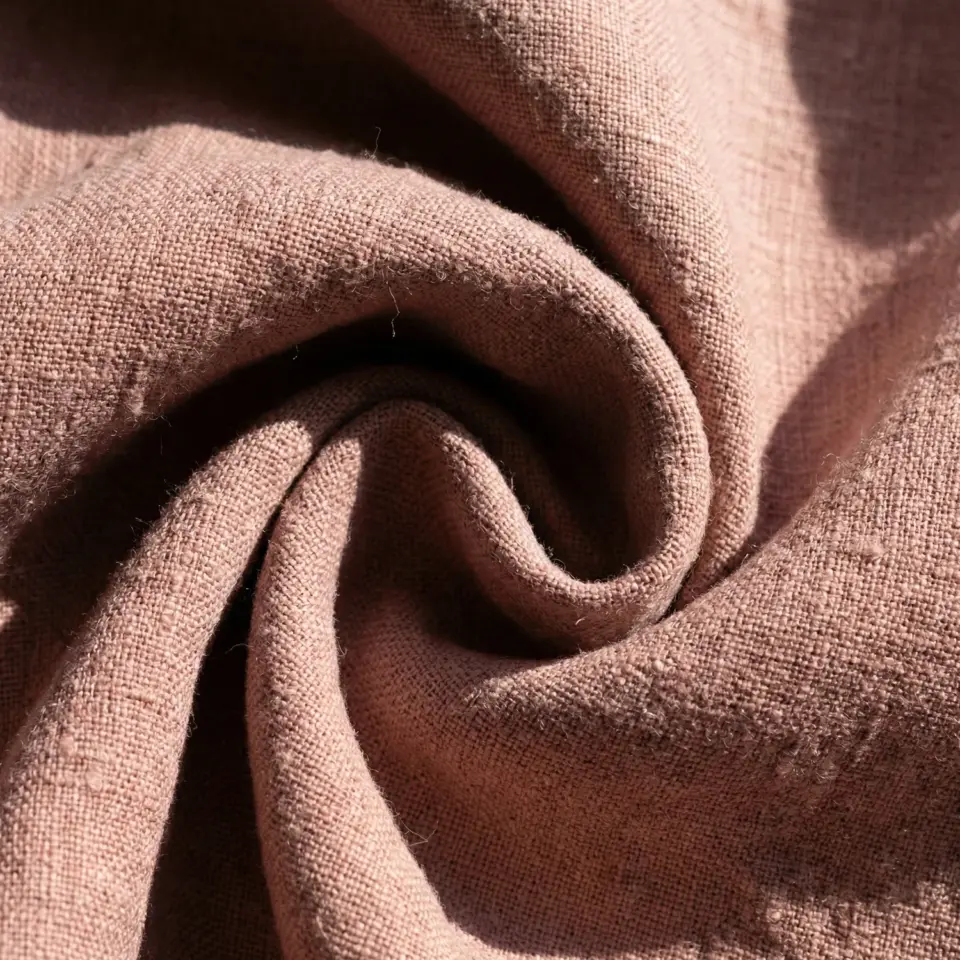 Close-up of textured brown fabric in a swirl, showcasing its detailed weave and cozy appearance.