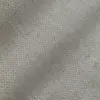 Close-up texture of woven fabric in beige tones, showing intricate pattern and detail.