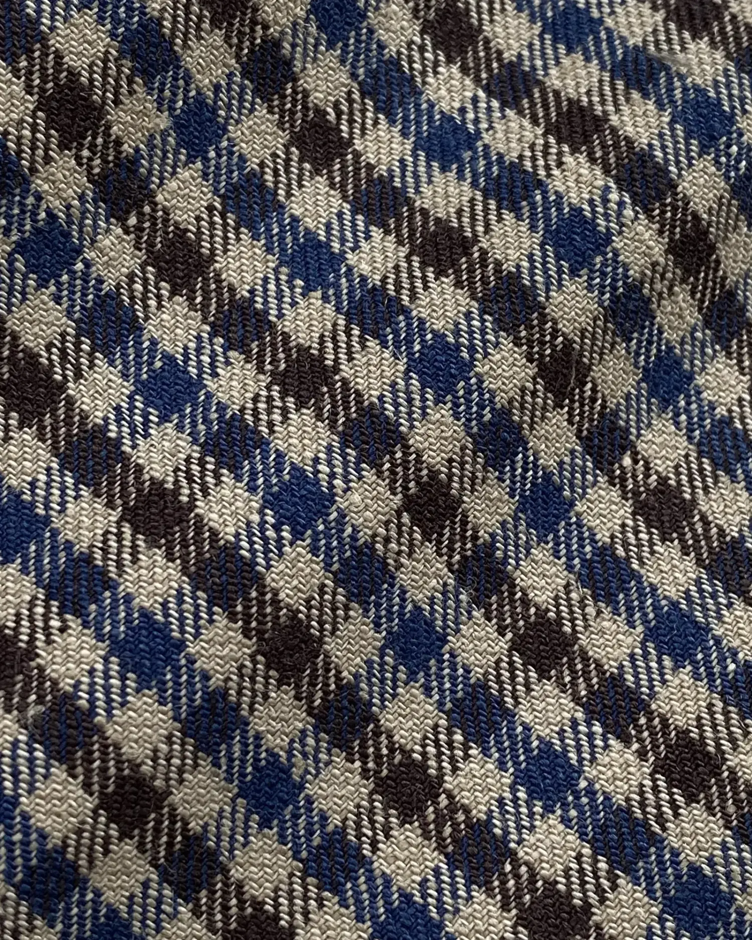 Blue and grey plaid fabric texture with intricate woven pattern.