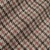 Close-up of a red and brown houndstooth fabric pattern, showcasing its intricate design and texture.