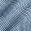 Close-up of textured blue and white houndstooth fabric pattern.