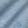 Close-up of textured blue fabric with a subtle woven pattern.