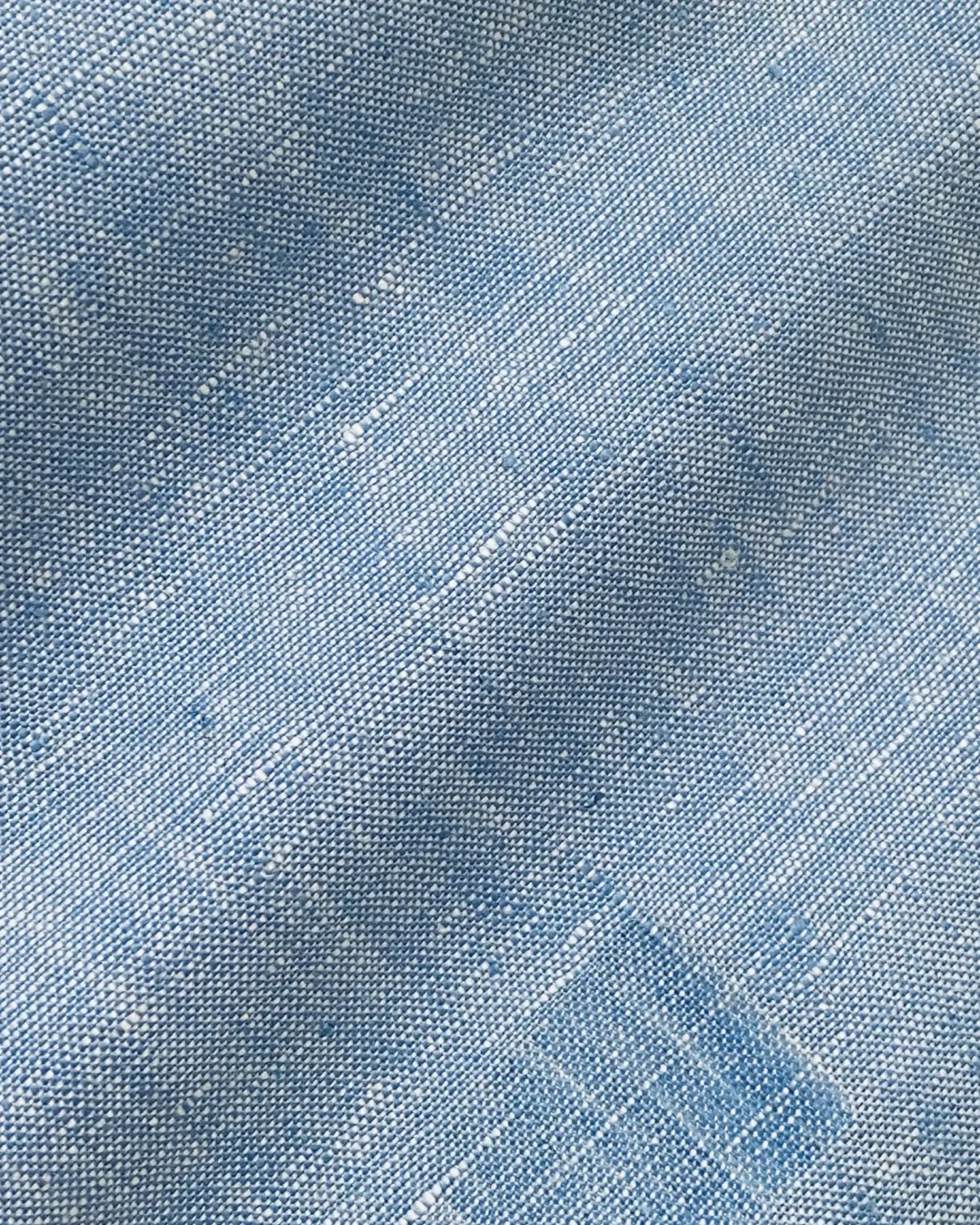 Close-up of textured blue fabric with a subtle woven pattern.