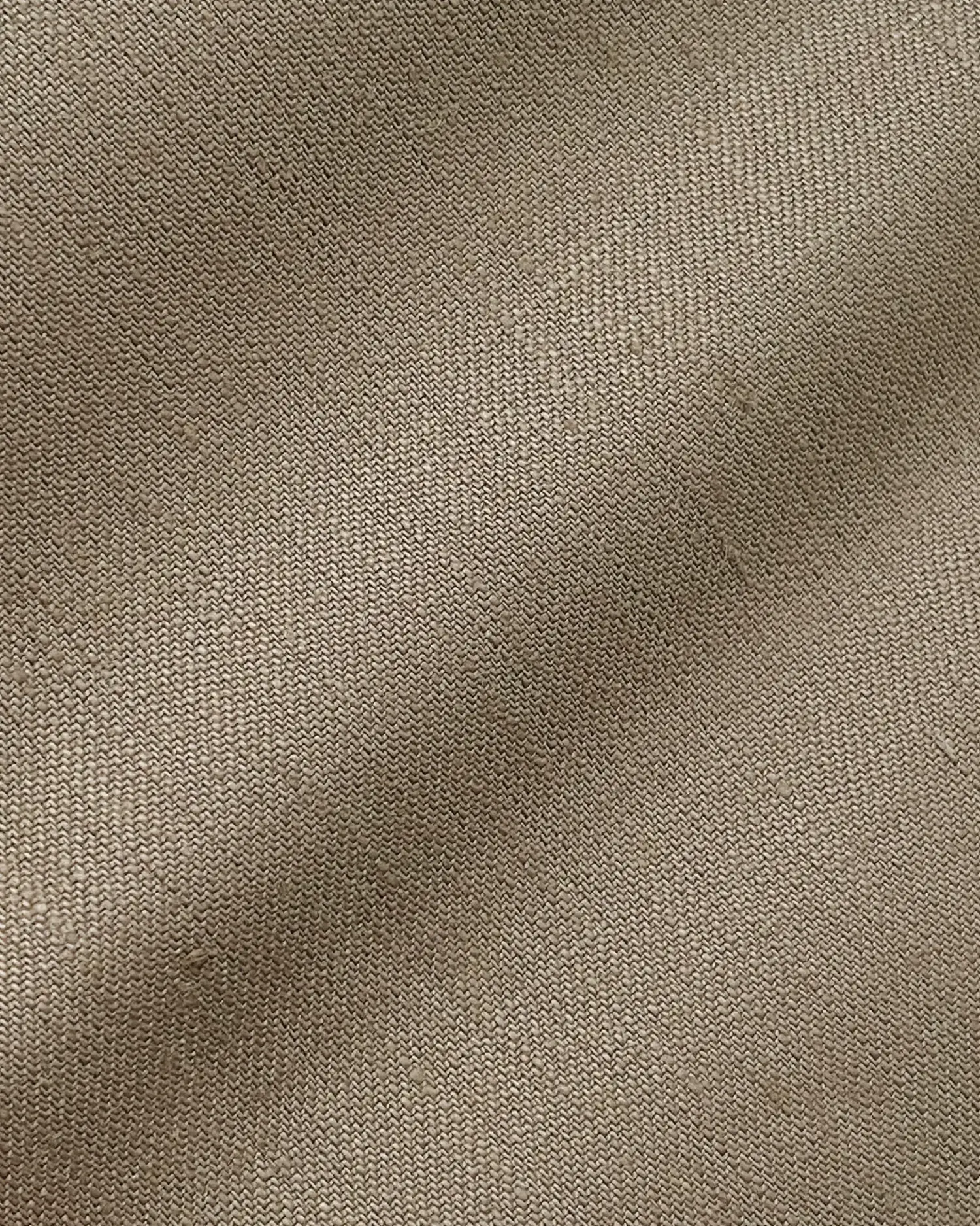 Close-up of textured brown fabric, showcasing a detailed weave pattern ideal for upholstery or fashion design.