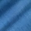 Close-up of textured blue fabric, showcasing detailed weave pattern for textile design or fashion inspiration.