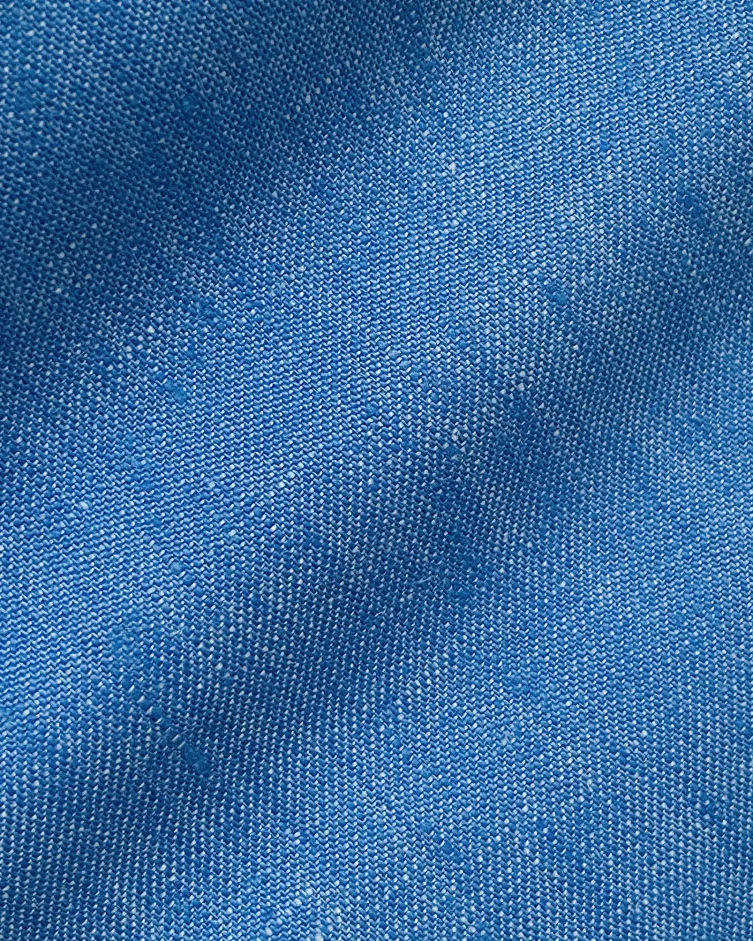 Close-up of textured blue fabric, showcasing detailed weave pattern for textile design or fashion inspiration.