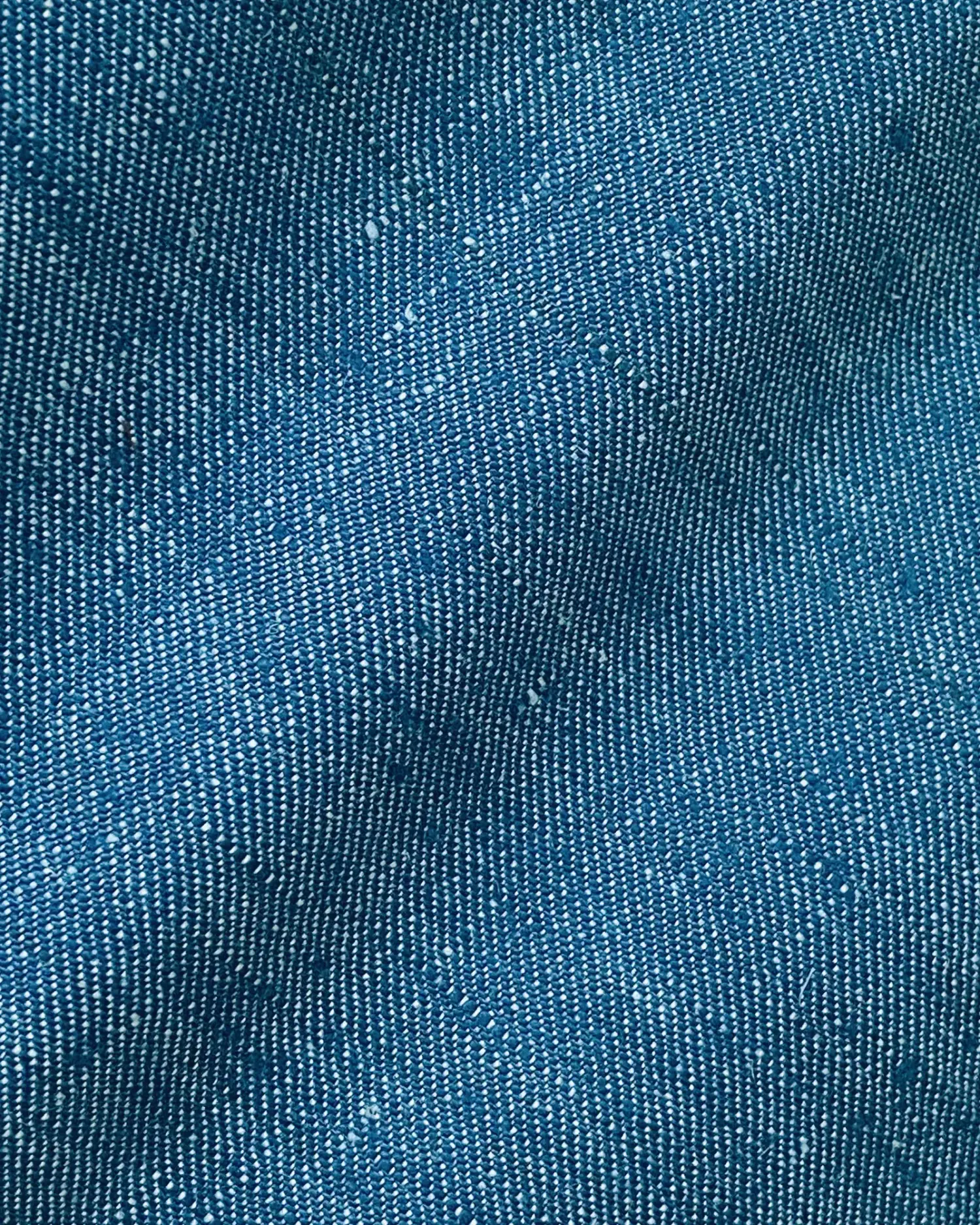Close-up of blue textured fabric with detailed woven pattern.